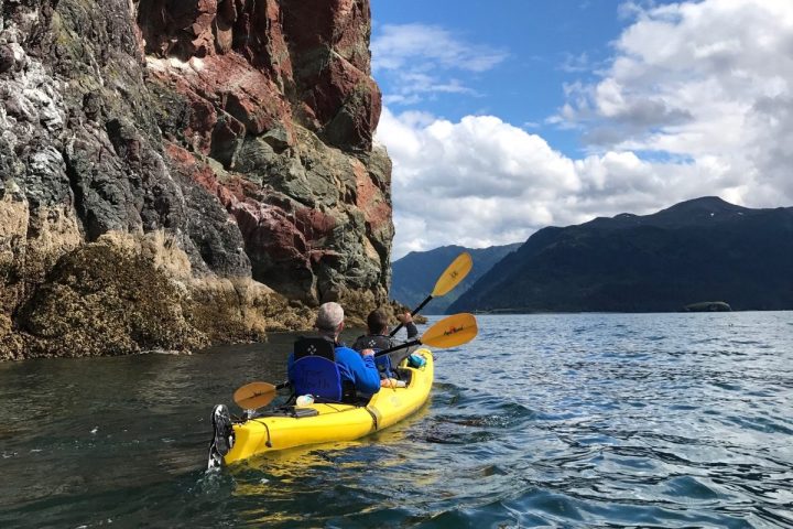 a yellow boat sitting on top of a body of water