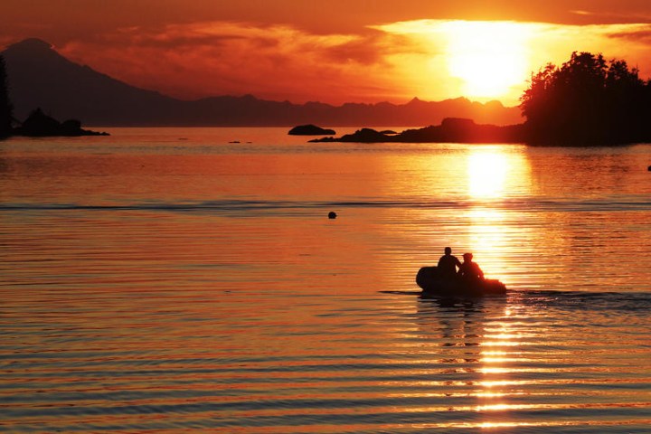 couple on boat in Tutka Bay at sunset